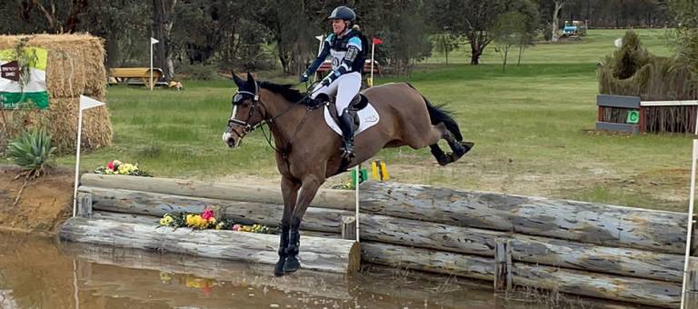 Picture of Emily Gray and Tradie jumping into the water at Dryandra CCI